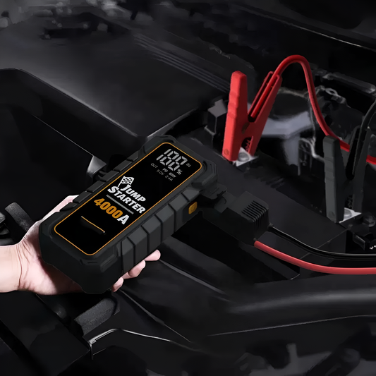 Car jump starter being used to charge a car battery with visible branding.